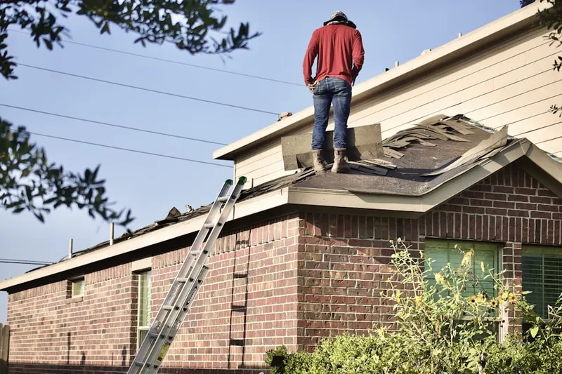 Professional roofer working on a residential roof in Loxahatchee Club